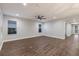 Bright living room featuring hardwood floors and ceiling fan at 12232 Perennial Pl, Lakewood Ranch, FL 34211