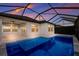 Enclosed pool with lake view at sunset at 12232 Perennial Pl, Lakewood Ranch, FL 34211