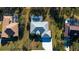 Aerial view of three homes with pools and lush landscaping at 13618 2Nd Ne Ave, Bradenton, FL 34212