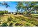 Spacious backyard with lush grass and mature trees providing shade at 13618 2Nd Ne Ave, Bradenton, FL 34212