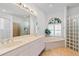 Elegant bathroom with double vanity, soaking tub, and glass block shower at 13618 2Nd Ne Ave, Bradenton, FL 34212