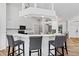 Modern kitchen with white cabinets, breakfast bar, and stainless steel appliances at 13618 2Nd Ne Ave, Bradenton, FL 34212