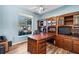 Home office with built-in wooden desk and shelving at 13618 2Nd Ne Ave, Bradenton, FL 34212