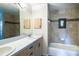 Bathroom featuring double sinks, a tub, and neutral tile at 1496 Palm View Rd, Sarasota, FL 34240