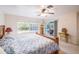 Bedroom featuring a ceiling fan, large windows, and a sliding glass door to the pool at 1496 Palm View Rd, Sarasota, FL 34240