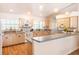 Bright kitchen featuring wood floors, stainless steel appliances, and plenty of natural light at 1496 Palm View Rd, Sarasota, FL 34240