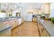 Bright kitchen featuring ample counter space, wood cabinets, white appliances and wood flooring at 1496 Palm View Rd, Sarasota, FL 34240