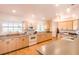 Spacious kitchen with light wood cabinets, grey countertops, and modern appliances at 1496 Palm View Rd, Sarasota, FL 34240