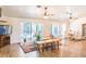 Bright living room with wood floors, a ceiling fan and sliding glass doors leading to the pool area at 1496 Palm View Rd, Sarasota, FL 34240