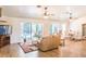 Bright living room with wood floors, a ceiling fan and sliding glass doors leading to the pool area at 1496 Palm View Rd, Sarasota, FL 34240