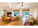 Living area featuring wood-look flooring and views of the backyard pool through sliding glass doors at 1496 Palm View Rd, Sarasota, FL 34240