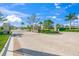 Brick paved community entrance with landscaping and gated access at 15033 Shady Palms Ln, Nokomis, FL 34275