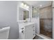 Clean bathroom with white vanity, glass block shower, and updated fixtures at 1601 32Nd W St, Bradenton, FL 34205