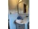 Simple bathroom with a pedestal sink and medicine cabinet at 1680 17Th St, Sarasota, FL 34234