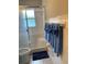 Clean bathroom with a shower/tub combo and blue towels at 1680 17Th St, Sarasota, FL 34234