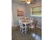 Small dining area with white table and floral chairs at 1680 17Th St, Sarasota, FL 34234