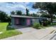 Gray house with pink door, driveway, and landscaping at 1680 17Th St, Sarasota, FL 34234