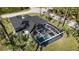 Property boasts a large screened pool and expansive backyard area at 1718 Jagust Rd, North Port, FL 34288