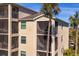 Close-up of condo building showcasing balconies and palm trees at 17520 Gawthrop Dr # 301, Bradenton, FL 34211