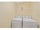 Laundry room with washer and dryer, and overhead shelving at 1761 Auburn Lakes Dr # 33, Venice, FL 34292