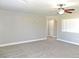 Large living room featuring neutral walls, new carpet, and a ceiling fan at 2215 18Th W Ave, Bradenton, FL 34205