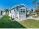 Side view of charming light blue single wide home at 226 Lancer Dr, Nokomis, FL 34275