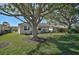 Spacious backyard with mature trees and manicured lawn at 2316 Harrier Way, Nokomis, FL 34275