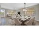 Open concept dining area with hardwood floors and modern light fixture at 2316 Harrier Way, Nokomis, FL 34275