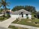 Single-story house with tile roof and attached garage, nicely landscaped at 2316 Harrier Way, Nokomis, FL 34275