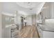 Open concept kitchen with island, stainless steel appliances, and breakfast bar at 2316 Harrier Way, Nokomis, FL 34275