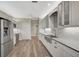 Modern kitchen with farmhouse sink and stainless steel appliances at 2316 Harrier Way, Nokomis, FL 34275