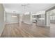 Open-concept living room with kitchen island and hardwood floors at 2316 Harrier Way, Nokomis, FL 34275