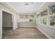 Bright sunroom with multiple windows and hardwood floors at 2316 Harrier Way, Nokomis, FL 34275