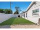 The backyard shows a well-manicured lawn, white fence, and the side of the home's exterior at 2401 15Th W St, Palmetto, FL 34221