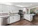 Bright kitchen featuring stainless appliances, white cabinetry, granite countertops, and wood floors at 2401 15Th W St, Palmetto, FL 34221