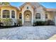 Impressive entryway with stone accents, arched entry, and a grand staircase at 24421 Tangelo Ave, Punta Gorda, FL 33980