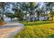 Home with circular driveway and lush landscaping at 24421 Tangelo Ave, Punta Gorda, FL 33980