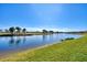 Serene waterfront view, showcasing a calm lake and green landscape at 25261 Spartina Dr, Venice, FL 34293