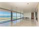 Living room with stunning water views and sliding doors at 320 S Shore Dr, Sarasota, FL 34234