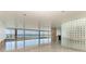 Spacious living area with glass block feature wall and water views at 320 S Shore Dr, Sarasota, FL 34234