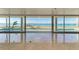 Bright living room with floor-to-ceiling windows and water views at 320 S Shore Dr, Sarasota, FL 34234
