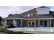 Back exterior of home with pool, patio, and modern design at 32206 Grand National Drive, Myakka City, FL 34251