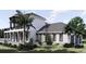 Two-story home with gray roof, white siding, stone accents, and a balcony at 32206 Grand National Drive, Myakka City, FL 34251