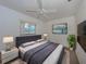 Main bedroom with king-size bed, large TV and plenty of natural light at 3755 S School Ave # 54, Sarasota, FL 34239