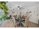 Bright dining room with a large granite table, wicker chairs, and access to the outdoors at 419 Clark Dr, Holmes Beach, FL 34217