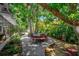 Relaxing patio with seating area, surrounded by lush tropical landscaping at 419 Clark Dr, Holmes Beach, FL 34217