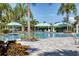 Relaxing community pool with striped cabanas and lounge chairs at 4239 Cottage Hill Ave, Parrish, FL 34219