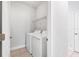 Laundry room with washer, dryer, and overhead shelving at 4239 Cottage Hill Ave, Parrish, FL 34219
