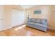 Bedroom with gray couch, hardwood floors, and white closet doors at 4279 Oakhurst E Cir # 3044, Sarasota, FL 34233