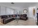 Spacious living room featuring a large leather sectional and wood-look floors at 4406 Wynkoop Cir, Port Charlotte, FL 33948